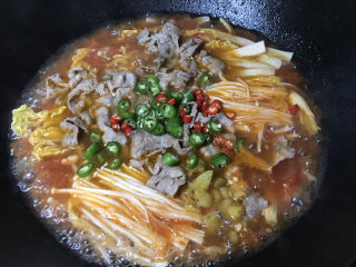 16、金针菇肥牛卷,下青红椒、泡椒搅拌均匀,再煮一分钟即可