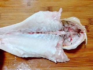 2、披红戴绿的蒜香红辣椒蒸黄鱼,破开肚皮，去掉内脏和鱼鳃，还有鱼头里面黑膜