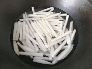 4、牛肉筷子萝卜,锅中加适量水,放入萝卜条,调入少许盐和食用油;