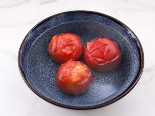 4、金针菇海兔汤,番茄用刀划十字刀后,加入开水烫一下去掉外皮。