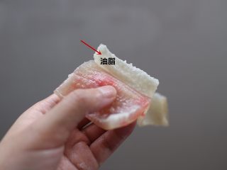 3、麻辣猪皮冻,煮好的猪皮,凉水过一下。然后用刀去除表面的油脂。这个油脂一定要去的干净一点,要不然到时候做好的成品会油腻腻的