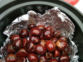 6、黑乐砂锅烤板栗,搅拌一下，使每个板栗表面都裹上一层植物油，把板栗放到砂锅里面准备开烤