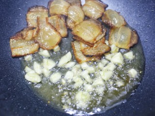 5、佛手瓜炒腊肉,加入大蒜爆香。