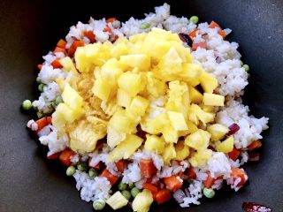 11、菠萝饭,再把菠萝和鸡蛋 液倒入锅中翻炒