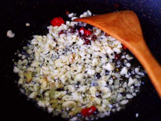 9、蒜香杏鲍菇青菜炒花肉,这个时候把绞碎的大蒜，放入锅中大火炒香。