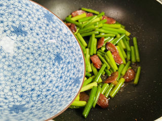 15、蒜苗炒腊肠,淋入少许热水翻炒至断生