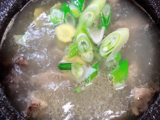 9、芋头排骨汤,加入大葱和姜片。