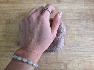 9、卡通龙猫豆沙包,将醒发好的黑全麦粉面团取出再次排气揉匀。