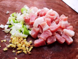 2、荠菜豆渣丸子,把猪肉洗干净后,用刀先切成小块,把葱姜切碎。