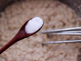 11、鲜美无比的鲅鱼饺子,这个时候先加入适量的盐调味,然后还是顺时针方向搅拌上劲。