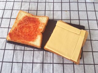 6、宝宝辅食12M➕彩虹????芝士吐司,在吐司上面均匀地涂上番茄酱然后把芝士片铺满吐司，也可以用奶酪碎哦