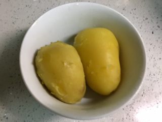 4、圆土豆+芝士土豆饼,把土豆放凉水冲一下，剥去皮。