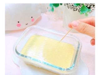 7、酸奶芒果糕,倒入面糊，盖保鲜膜扎小孔，热水上锅蒸20分钟