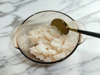 5、#辅食计划#蒸出来的虾肉鸡蛋卷,之后放入器具中，加入少许料酒用勺子拌均匀。(麟虾肉更妙的是它不会有腥味。)