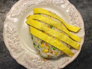 13、菠萝造型炒饭,先将蛋皮斜着放在炒饭上