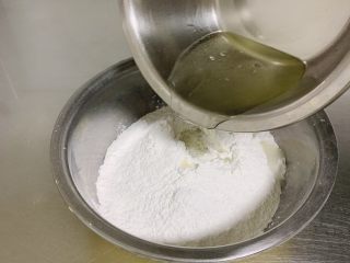 6、东北油炸糕,将烧开的沸水迅速倒入糯米粉中。