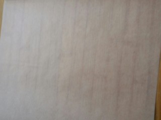 9、花生瓜籽麻糖,在面板上提前铺上一层油纸(防粘)。