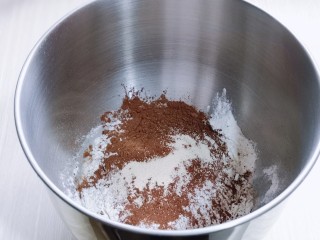 2、懒人必做～巧克力贝果,将牛奶，盐，糖，可可粉，高筋面粉，酵母粉加入厨师机中，启动厨师机1档揉面10分钟。