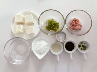 1、宝宝辅食：豆腐箱（肉末酿豆腐）,准备好所有食材，将老豆腐切成方型块（大概长3cm,宽3cm，厚2.5cm左右），猪肉剁成肉糜，青椒切细丁。