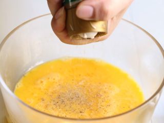 6、银鱼炒蛋,再磨入白胡椒粉。