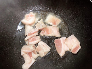 7、蘑菇炒肉,锅中倒入油，加热至五成热，放入五花肉，爆炒。