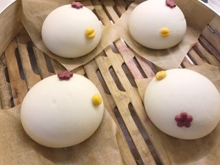 11、小鸡馒头,取黄色面团,分成0.5克的小面团,揉圆后用刮板在中间按一下,沾少许水放在白色面团合适位置当小鸡嘴巴