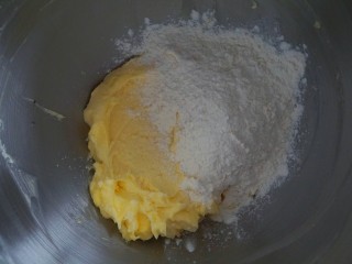 4、年货必备甜品|香酥曲奇,加入蛋黄搅拌均匀。筛入低粉。