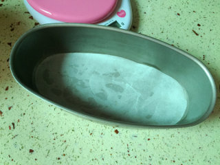 9、轻乳酪蛋糕,模具底部垫上油纸,另取黄油涂抹模具壁四周。