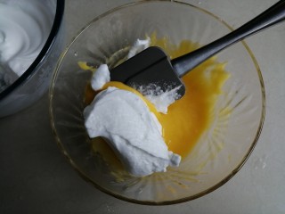 11、戚风纸杯蛋糕,用刮刀取1/3打发好的蛋白霜到蛋黄糊里，从底部向上翻拌并切拌均匀