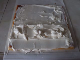 15、草莓香草奶油蛋糕卷,蛋糕片距离前端3cm多抹一些奶油，抹成小山丘，蛋糕片前端与尾部奶油抹平^o^