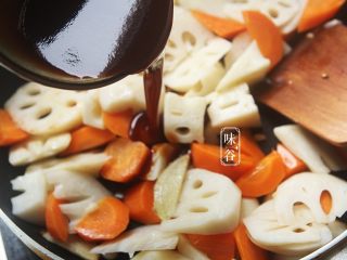 10、开胃下饭的糖醋鲜藕,倒入调好的糖醋汁，翻炒均匀上色后转中小火，让胡萝卜和莲藕吸收糖醋汁；