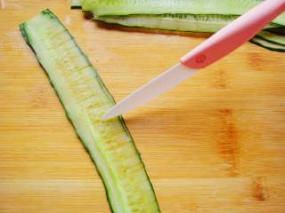 5、黄瓜花朵拼盘,两片放在一起，用刀划出均匀的长条，顶端不要切断。