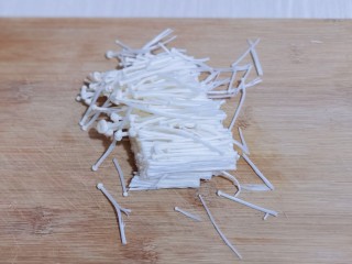 2、酸甜开胃~番茄金针菇冬瓜汤,首先将金针菇去根,再从中间切断!