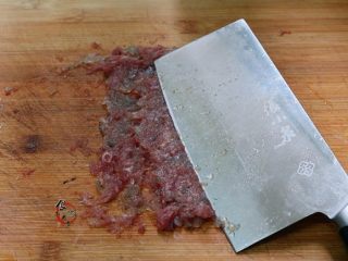 3、晶莹剔透又鲜又爽的水晶虾饺,再用刀将剁好的肉碎压烂成肉糜，一手抓住刀柄，一手按在刀面上，稍微用力来回压几遍，比搅拌机搅的还好