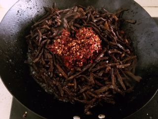 13、冷吃牛肉,倒入辣椒油，快速翻炒。 