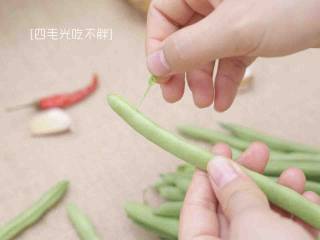1、干煸四季豆,将四季豆摘去老筋;