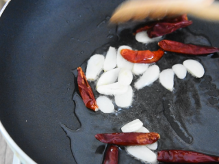 6、饭店必点的干锅花菜，是这么做出来的！,锅中倒入少许油，爆香蒜片、辣椒干