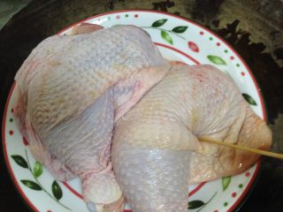 2、蜜汁叉烧烤鸡腿,用竹签在鸡肉上扎孔,尽量的多以便进味