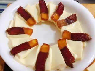 3、腊肉蒸豆腐卧蛋,腊肉片摆在嫩豆腐上