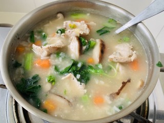 12、香菇滑鸡粥,鸡肉全部熟透,尝试味道正好,把青菜放入锅中搅匀,可以出锅开吃