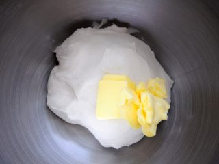 6、经典版蛋黄酥,将提前软化好的黄油加入面团，刚开始可以先用手来和，尽快的将黄油揉开初步融入面团，这样可以提高厨师机效率，否则，由于600g的面团对它来说实在是太少了，只能躺在机器的底部，再加上黄油比较光滑，机器的搅拌勾总是勾不住面团，在那空转。如果用小点的机器或是和更多量的面团，这个问题就不存在了。