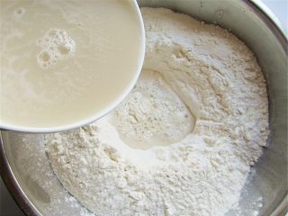 2、玉米馅葱香饼,将面粉倒入盆边较干燥的盆内，中间挖个坑，分次倒入，边倒边用刮刀和面