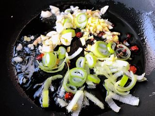 3、家焖黄花鱼,锅中放入底油加热放入花椒和八角炸香再放入葱姜蒜爆香