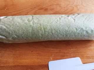 21、抹茶奶油卷,借助烤盘纸辅助卷起来。放入冰箱冷冻一小时。