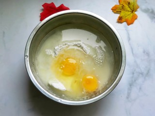 5、懒人版土豆馅饼,面粉中打入两个鸡蛋,放250ml清水。