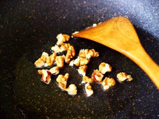 5、核桃仁虾干时蔬蛋炒饭,另起锅倒入剩下的10克花生油烧热后，先把核桃仁小火慢慢炒香。