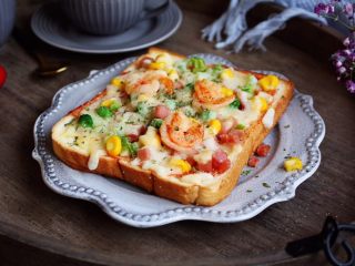 13、鲜虾吐司披萨,在鲜虾吐司披萨上撒少许的黑胡椒碎即可。