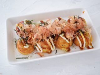 15、章鱼小丸子,最后装盘撒上沙拉酱、照烧汁、海苔粉、海苔丝、木鱼花即可