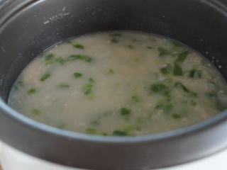 5、电饭锅芥菜肉粥,往肉末里加水,搅拌成肉末水,然后倒入粥里,搅拌均匀。我们不喜欢大颗粒的肉末在粥里,这个办法可以让肉末在粥里散开。按照个人口味,加入油,盐和胡椒粉调味。
