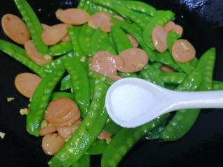 12、荷兰豆炒香肠,放入半小勺盐急火快炒。